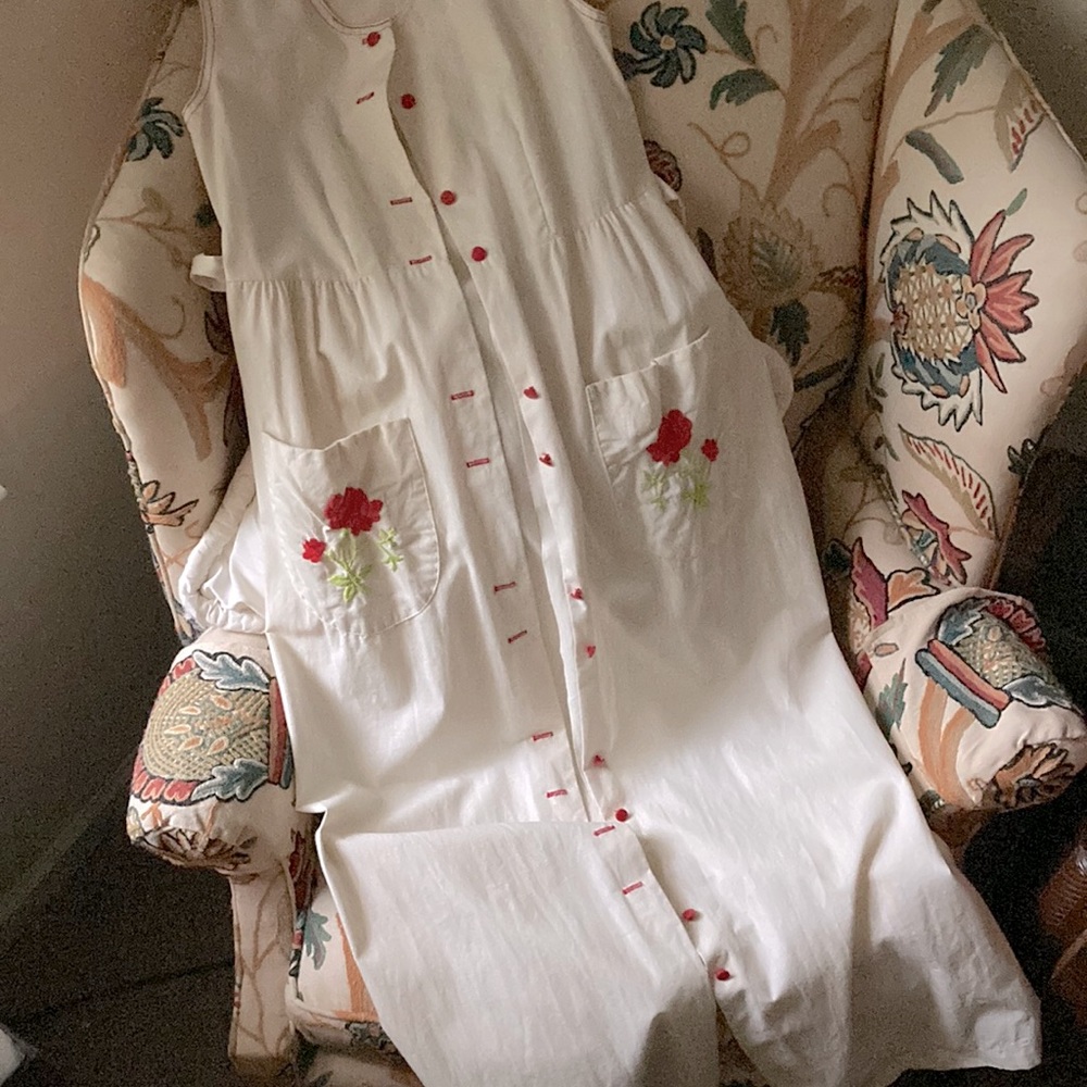 Beige robe w red embroidery & tie in back.